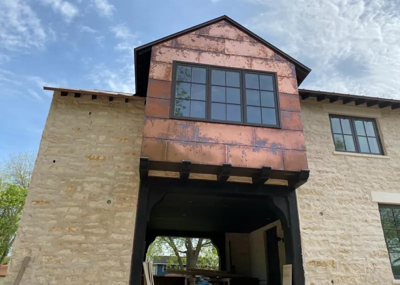 Copper metal panel facade on a stone building for Skylight Installation in Rio Linda