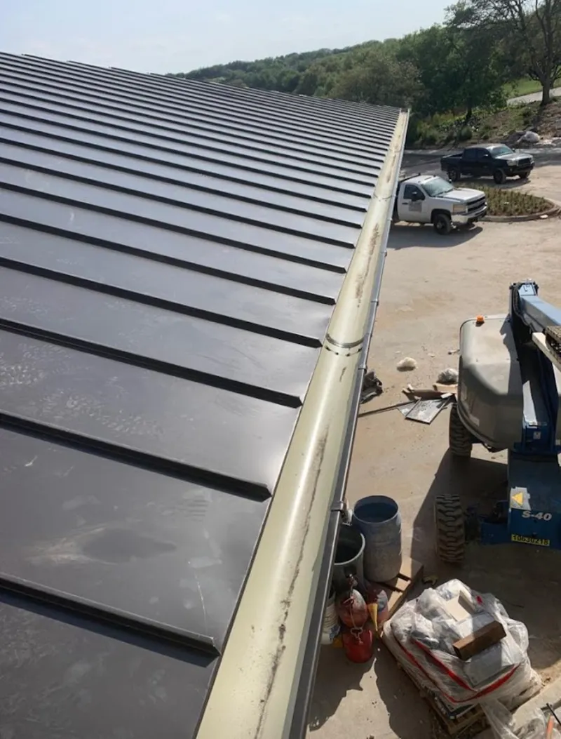 Standing seam panel and gutter detail on a metal roofing jobsite in Rio Linda